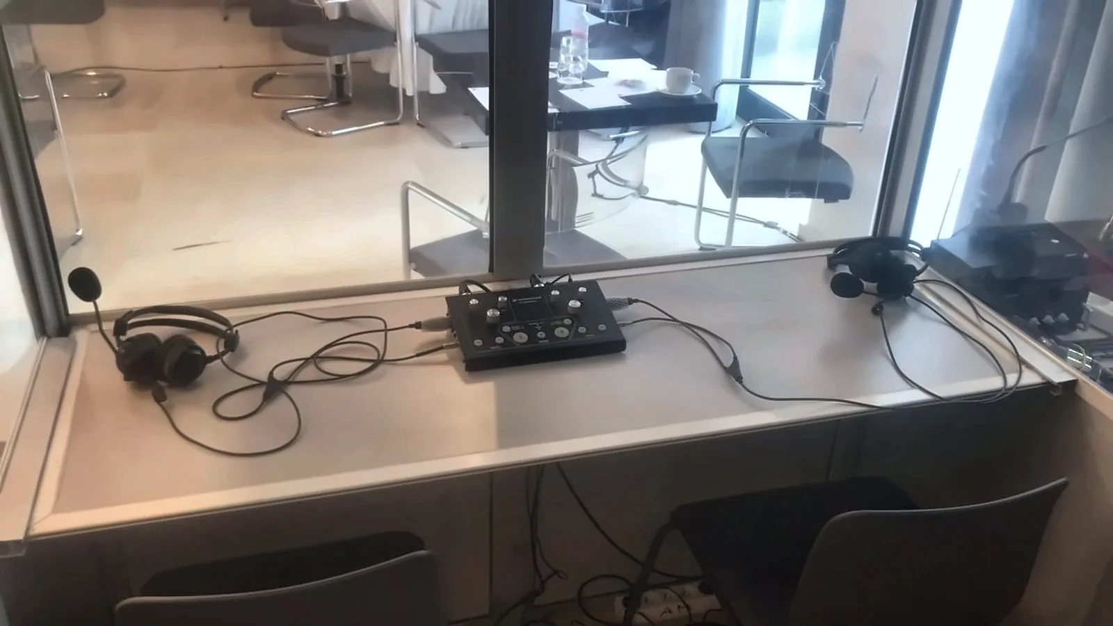Pupitre d'interprète et casques dans une cabine de traduction simultanée