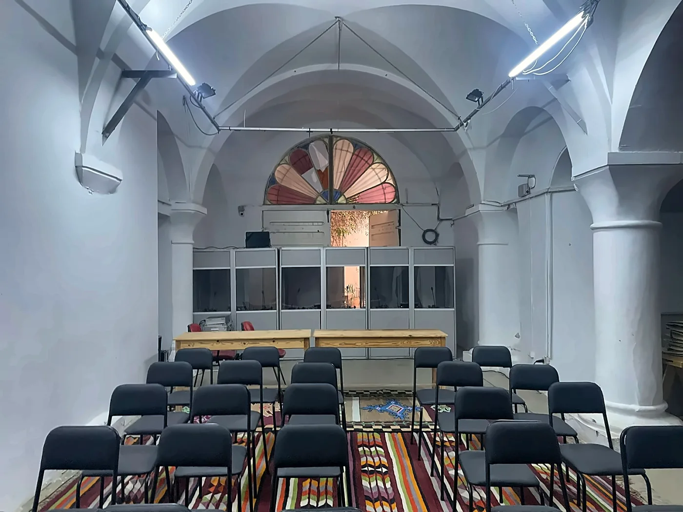 Six simultaneous interpretation booths set up in a vaulted heritage venue